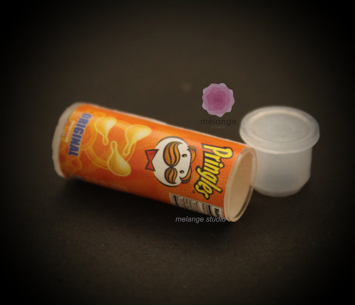 Miniature resin Pringles cans in orange, green and red variants for dollhouse and diorama displays