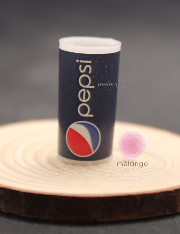 Miniature navy blue fast-food drink cup on a wooden slice