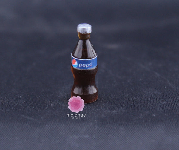 Miniature dark cola bottle with a silver cap